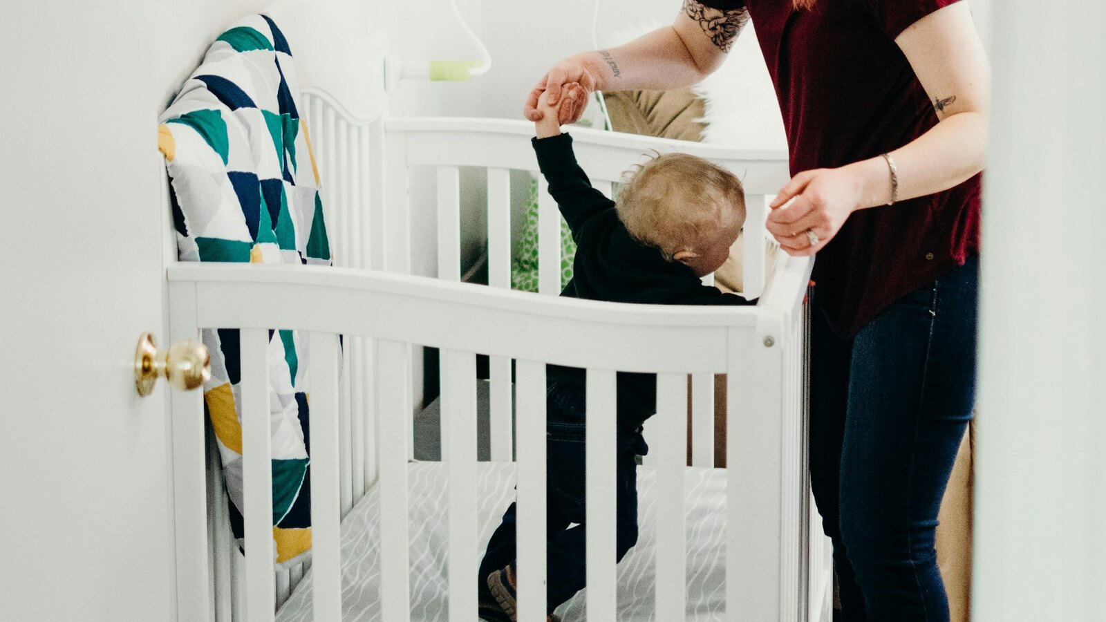 A parent settling their toddler in at nursery